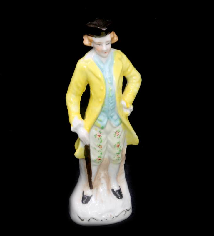 Vintage Staffordshire style figurine of a man looking dandy